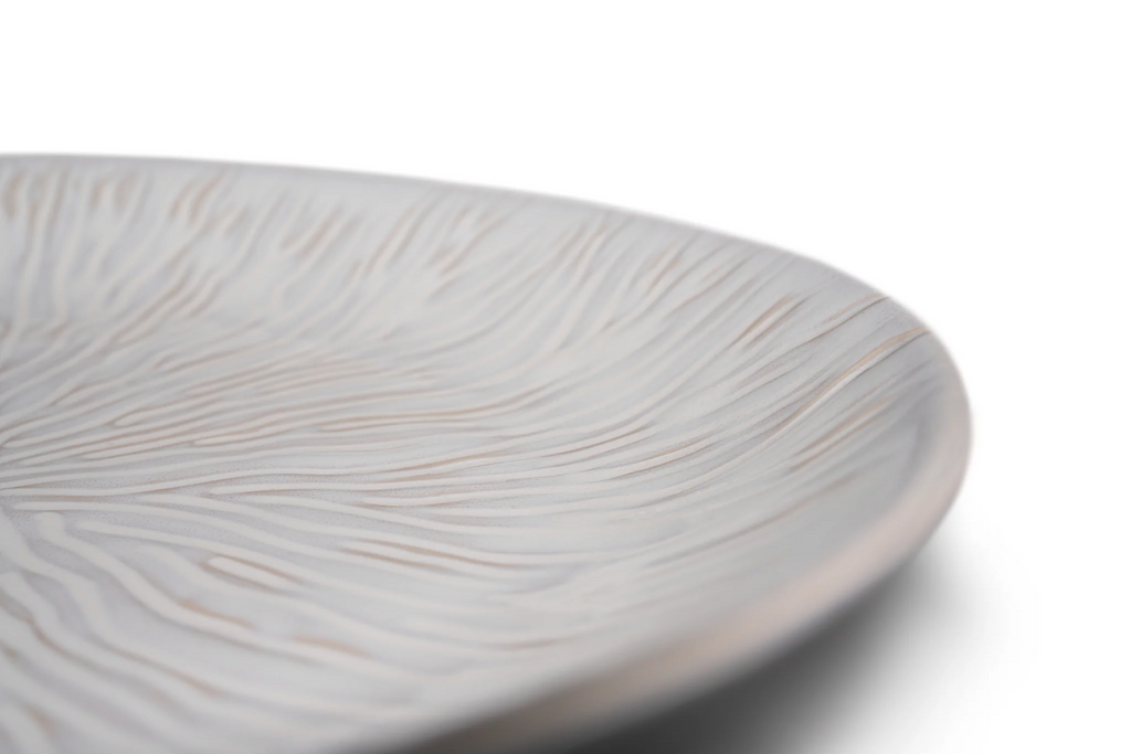 This elegant Harvest Field Platter is perfect for serving up your favorite autumn dishes. With its spacious design and durable construction, it's the ideal choice for any fall gathering. Impress your guests and elevate your dining experience with the Harvest Field Platter by Simon Pearce.