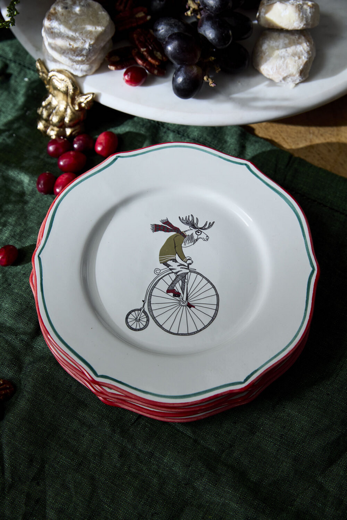 The E+E Cocktail Plate Collection by Jessica Heimstra adds festive flair to your gatherings. These quirky ceramic plates feature hand-painted red and green rims and holiday-themed artwork decals, perfect for a playful holiday bar or dessert table. Food-safe and fun! Eugene Moose on Bicycle