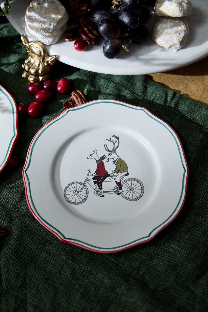 The E+E Cocktail Plate Collection by Jessica Heimstra adds festive flair to your gatherings. These quirky ceramic plates feature hand-painted red and green rims and holiday-themed artwork decals, perfect for a playful holiday bar or dessert table. Food-safe and fun! Frankie & Margie