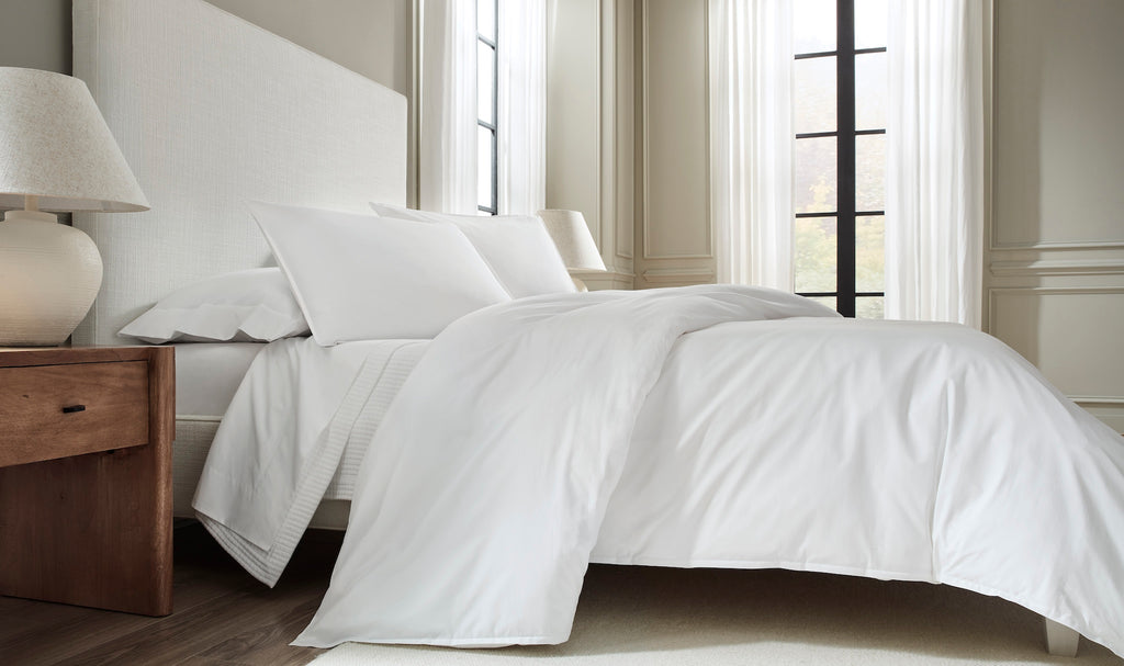 Sleep in the ultimate in luxury with our Giza 45 Corto Percale Sheets, Duvet Covers + Shams. Crafted in Italy from 100% Giza 45 Egyptian cotton, the white bedding features mini flanges and plain, clean hems for a sleek and sensible look. Experience the comfort and quality of Giza 45 Egyptian cotton.