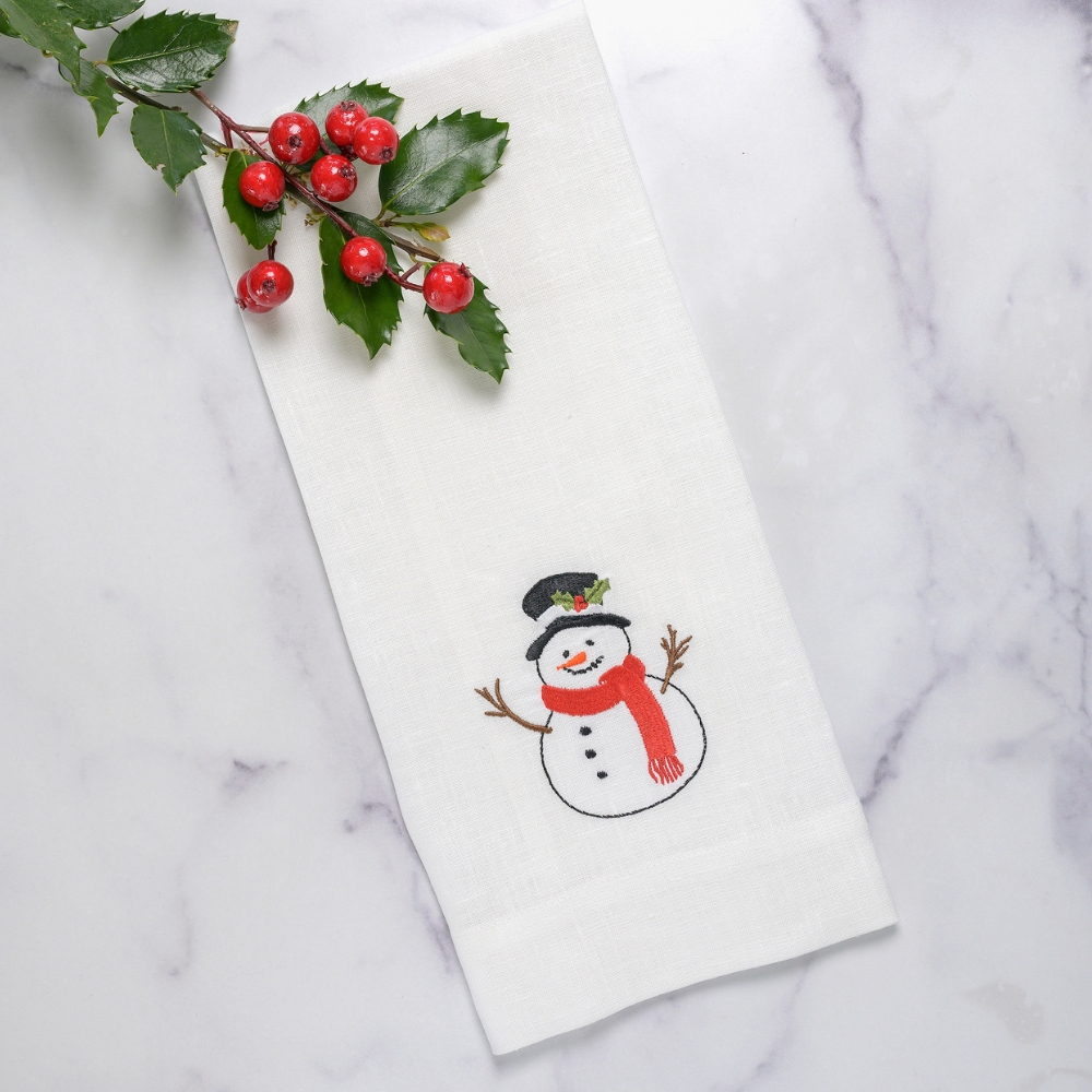 Introducing Frosty Towel, the perfect addition to your kitchen or bath. Made from 100% embroidered European linen, this festive snowman guest towel adds beauty to any part of your home. With a convenient tab on the back for hanging and made in Italy, it's the perfect combination of style and functionality.