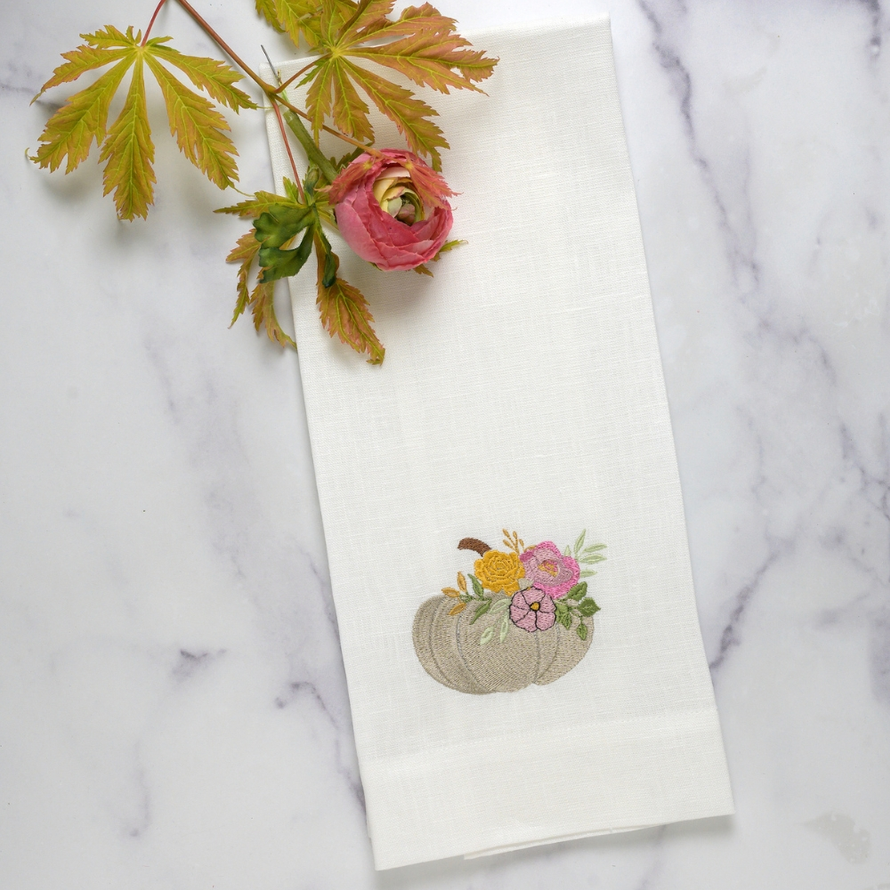 Add a touch of elegance to your kitchen or bathroom with our Floral Pumpkin Towel. Crafted from 100% embroidered European linen, this guest towel features a white pumpkin design with garden florals. Measuring 17x29", it also includes a tab on the back for easy hanging and is made in Italy for exceptional quality.