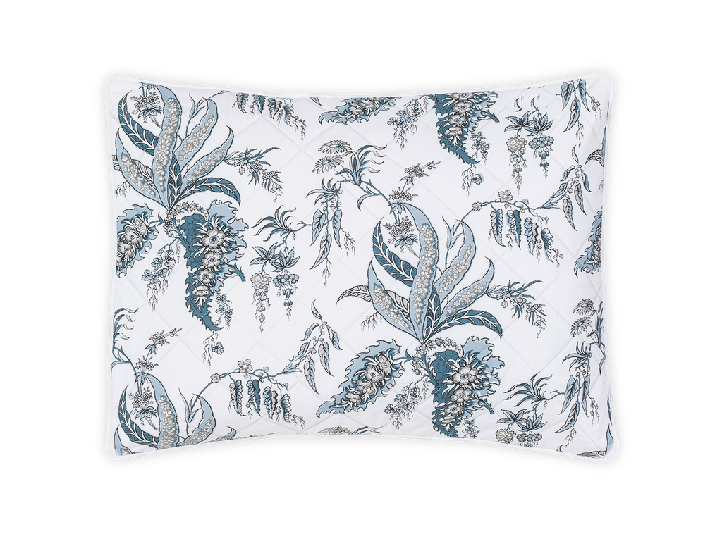 Apolline Quilted Sham, designed by Schumacher. This botanical print evokes classic sophistication and grace. Sewn from 100% Egyptian cotton percale, boasting a Mediterranean blue floral pattern and silvery grey hues. Large diamond quilting and white piped edges add an exquisite touch.