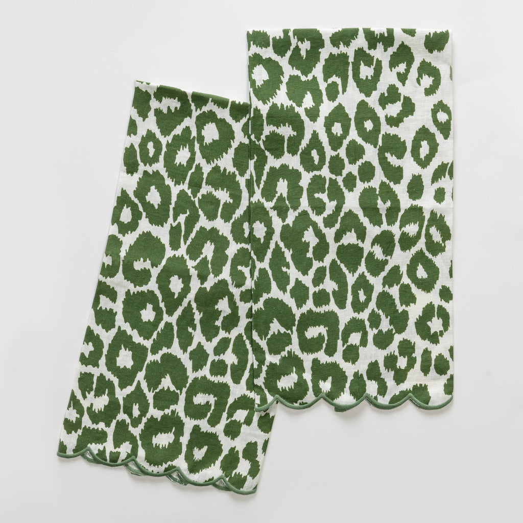 Matouk Schumacher Iconic Leopard Guest Towels in green animal print on white linen background and green embroidered scallop edge