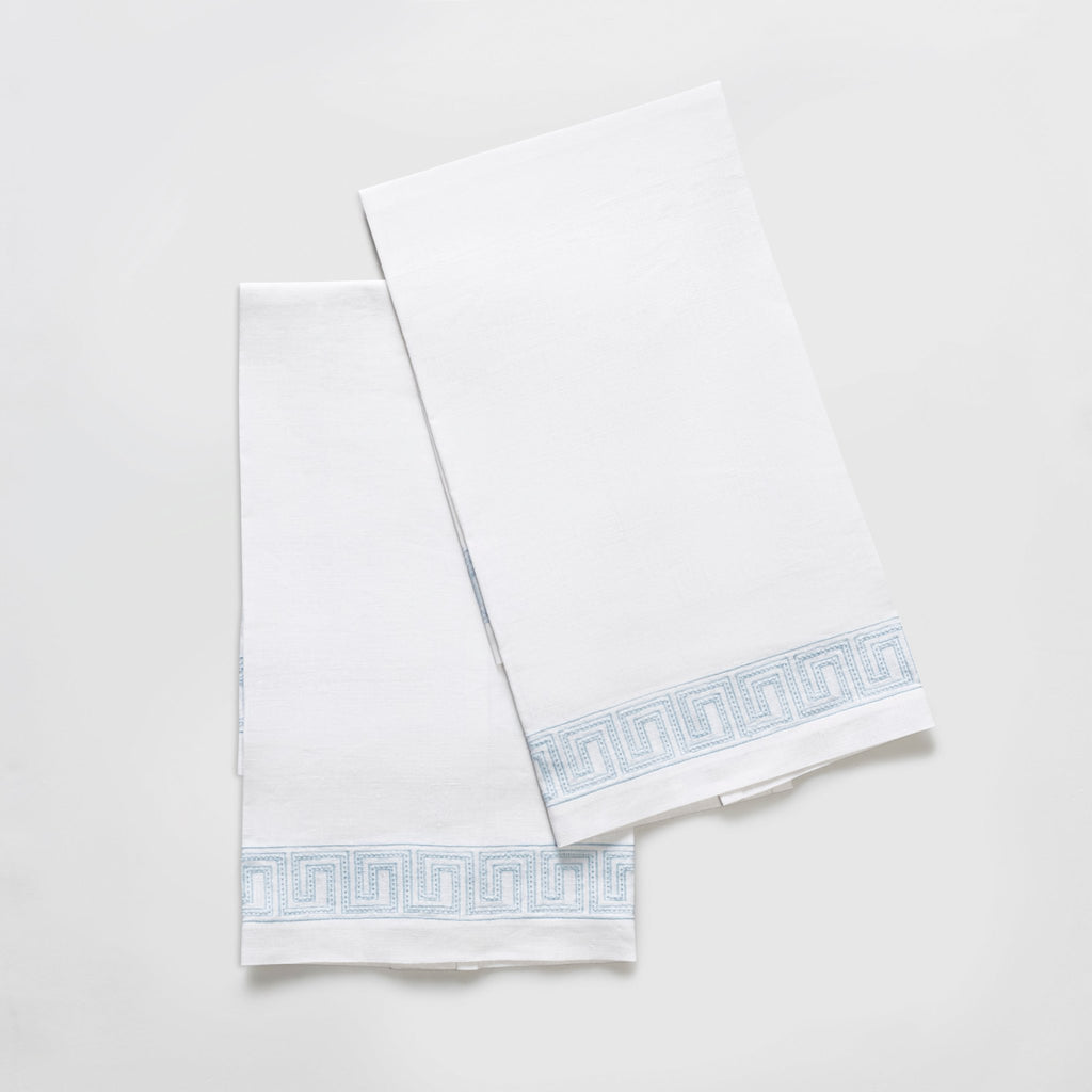 The Ophelia Guest Towels are the epitome of luxury and sophistication. Made from 100% linen, the towels feature an elegant Greek key pattern with meticulously light blue embroidered lines and dots inspired by Schumacher's beaded tape. These towels will elevate any bathroom with their classic design.