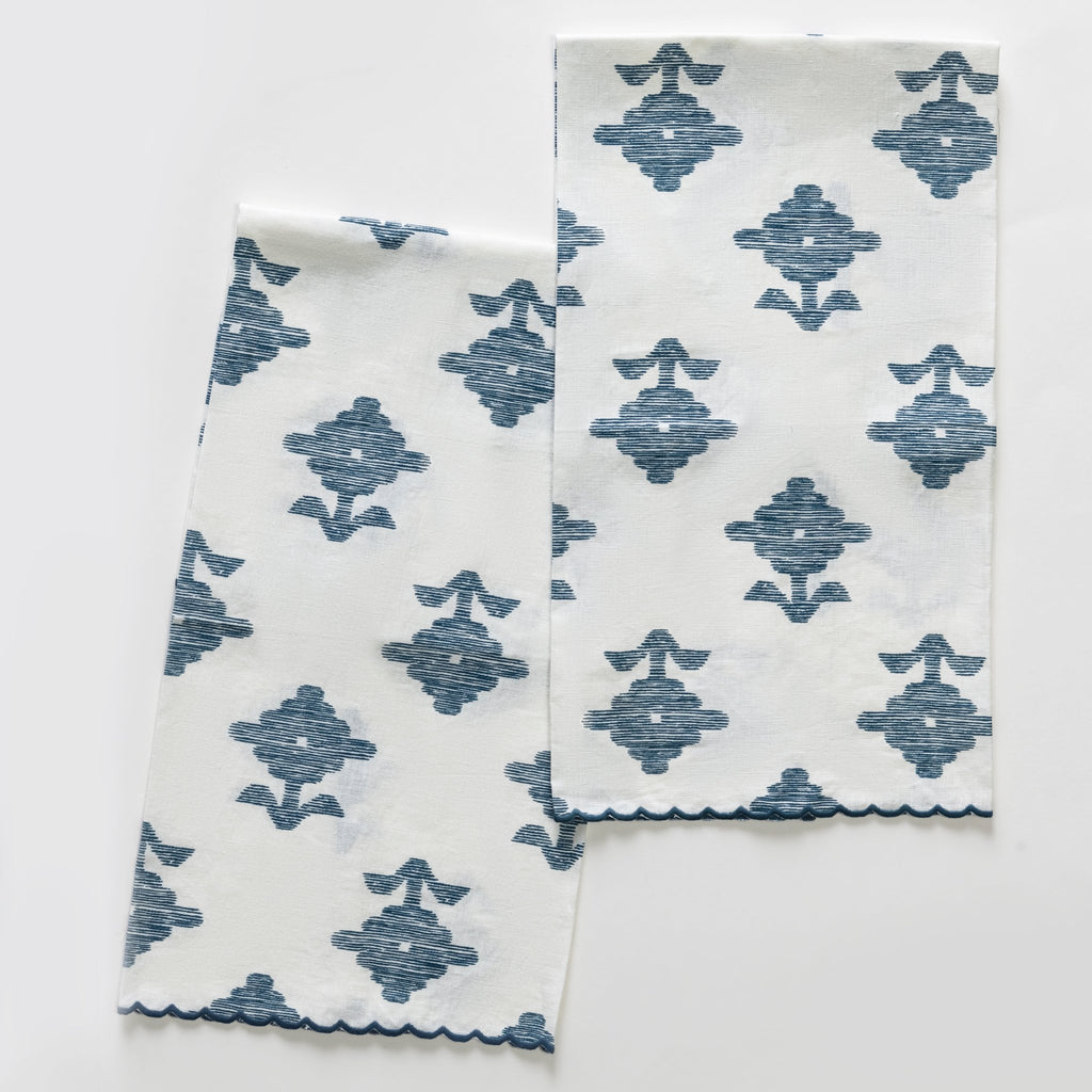 Elevate your guest bathroom with our Rubia Guest Towels from Matouk. Made in the USA from soft Portuguese linen, the set of 2 towels features a beautifully detailed navy blue blossom print inspired by Schumacher and delicate scalloped navy embroidery for an elegant touch.