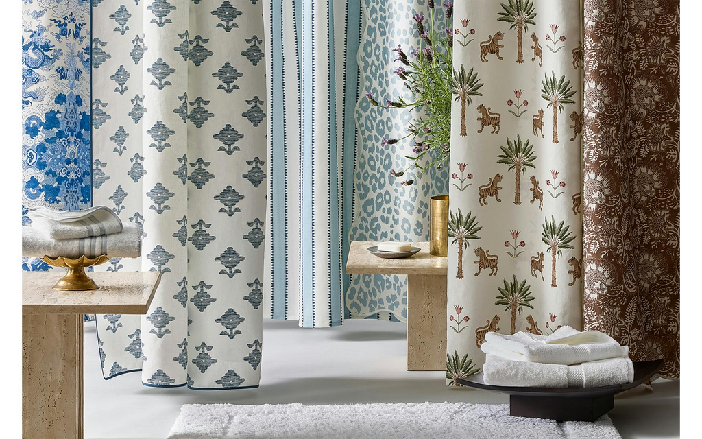 Matouk Shower Curtains Left to Right: Magic Mountain in Porcelain Blue, Rubia in Navy, Apollo Stripe in Sky, Iconic Leopard in Sky, Tiger Palm in Tigereye, and Granada Linen in Chestnut