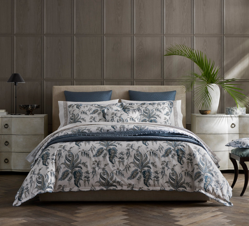 Introducing the Apolline Sheets, Duvet Covers + Shams by Matouk. Inspired by the graceful English countryside, this stunning botanical print features a white Egyptian cotton percale fabric with a Mediterranean blue floral pattern and silvery grey accents. With a subtle scallop edge, these sheets exude sophistication.