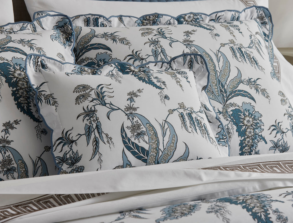 Introducing the Apolline Sheets, Duvet Covers + Shams by Matouk. Inspired by the graceful English countryside, this stunning botanical print features a white Egyptian cotton percale fabric with a Mediterranean blue floral pattern and silvery grey accents. With a subtle scallop edge, these sheets exude sophistication.