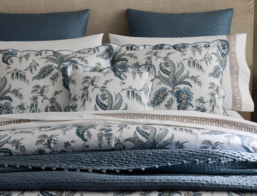 Classic sophistication. Matouk's Apolline Pillow Sham design draws from the graceful details of the English countryside creating a stunning all over botanical print from renowned designer, Schumacher. A crisp white Egyptian cotton percale fabric with a Mediterranean blue floral pattern with complements of silvery grey hues that is given a finishing touch with an ever so subtle embroidered scallop edge in a matching blue thread.