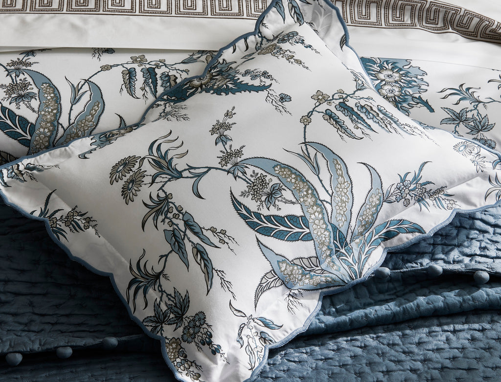 Introducing the Apolline Sheets, Duvet Covers + Shams by Matouk. Inspired by the graceful English countryside, this stunning botanical print features a white Egyptian cotton percale fabric with a Mediterranean blue floral pattern and silvery grey accents. With a subtle scallop edge, these sheets exude sophistication.