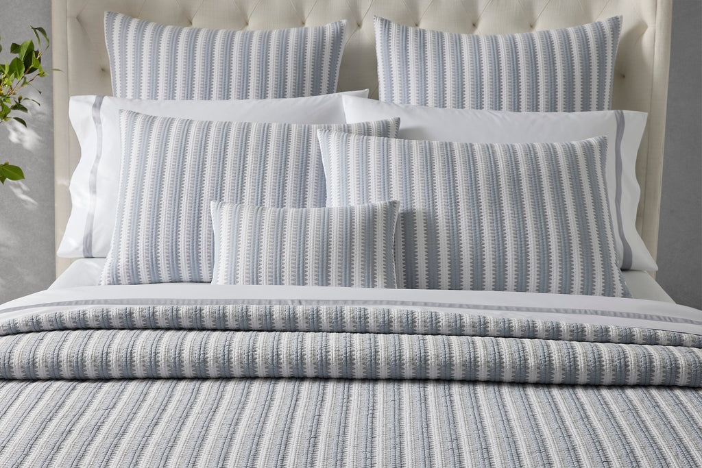 Expertly crafted in the USA with luxurious Italian fabric, Matouk's Apollo Stripe Matelassé coverlet and shams offer a comfortable and casual addition to your bedding. The 100% cotton shell and poly fill provide a minimal yet textural layer in a choice of Comet taupe or Dove blue & grey hues.