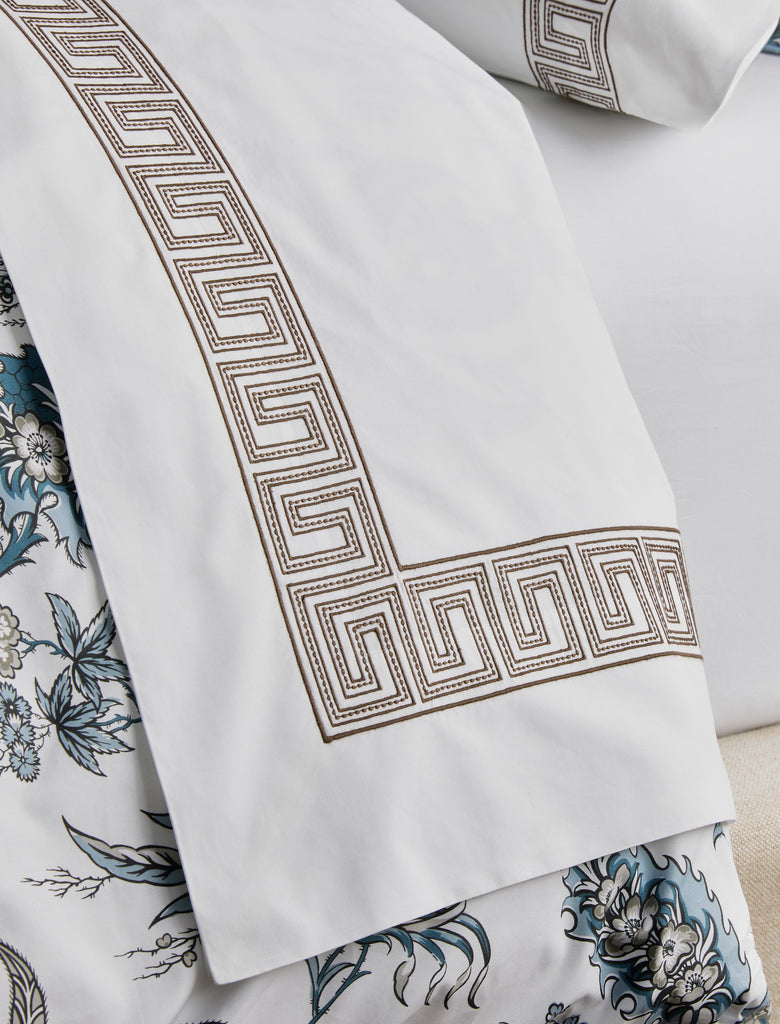 Experience the luxury of Matouk's Ophelia Flat Sheet. Crafted from crisp white 520 thread count Ceylon percale, these sheets feature a timeless Greek pattern reimagined with intricate embroidery. Mix and match with an array of colors for a stunning addition to any bedroom.