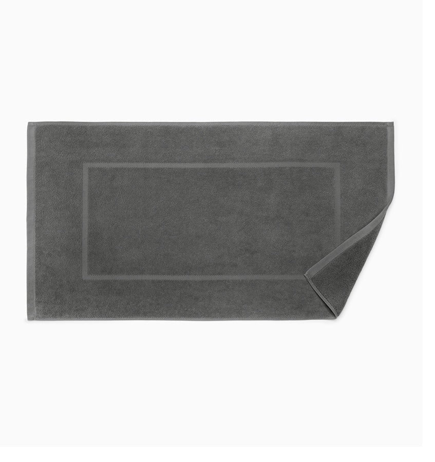 Elevate your bathing experience with Canedo Nuovo Bath Towels + Tub Mat. Crafted by Sferra from long-staple combed cotton, these towels offer a soft and velvety touch to your skin. The diamond-weave velour adds a touch of luxury, while the terrycloth absorbs moisture for a cozy embrace. Available in Charcoal Grey Tub Mat