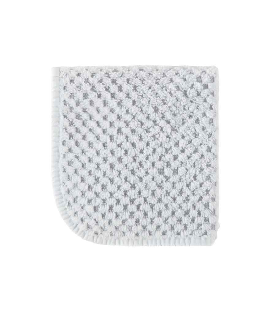 Introducing Catalina wash cloth, made from 100% cotton and weighing 565 grams for a luxurious feel. Imported from Portugal, these towels feature a two-tone checkerboard design with white trim and rounded corners. Hang easily with the towel loop for convenience.