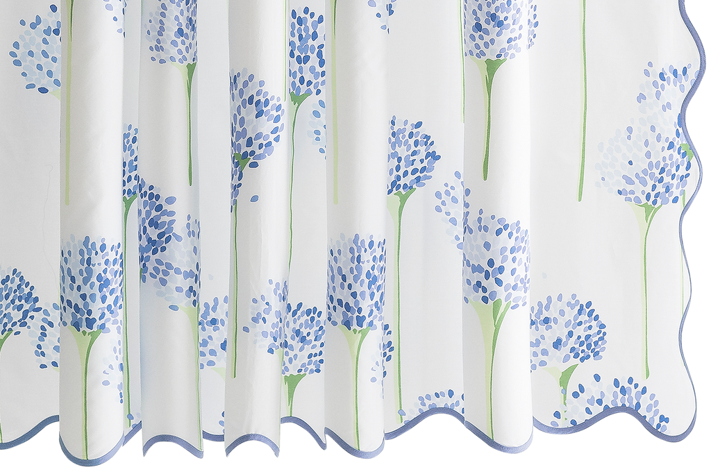 Introducing the Charlotte Shower Curtain, a Matouk mainstay. Made of luxurious white Egyptian cotton, this shower curtain boasts an all-over pattern of blue or lavender allium flowers, designed by Lulu DK. With a long wave scallop and complementing tape color, it's a timeless and elegant addition to your bathroom.