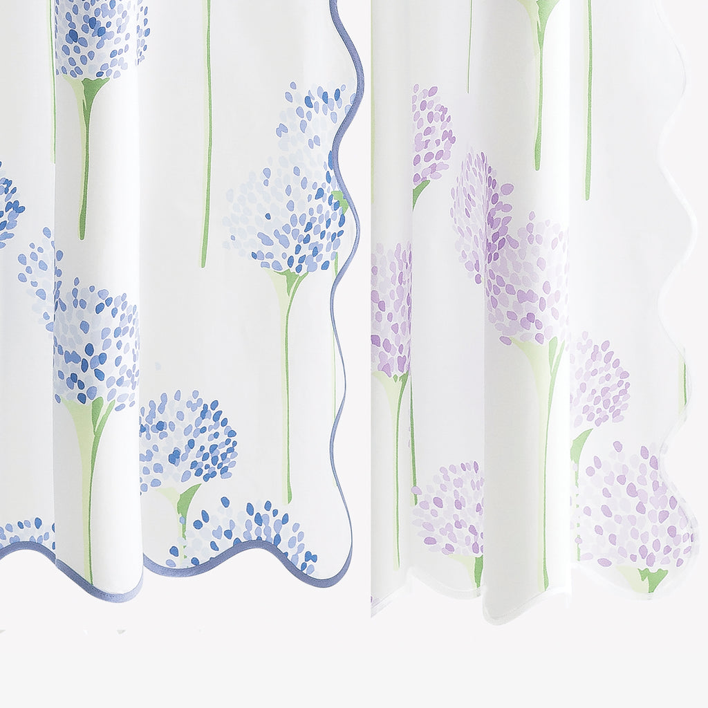 Introducing the Charlotte Shower Curtain, a Matouk mainstay. Made of luxurious white Egyptian cotton, this shower curtain boasts an all-over pattern of blue or lavender allium flowers, designed by Lulu DK. With a long wave scallop and complementing tape color, it's a timeless and elegant addition to your bathroom.