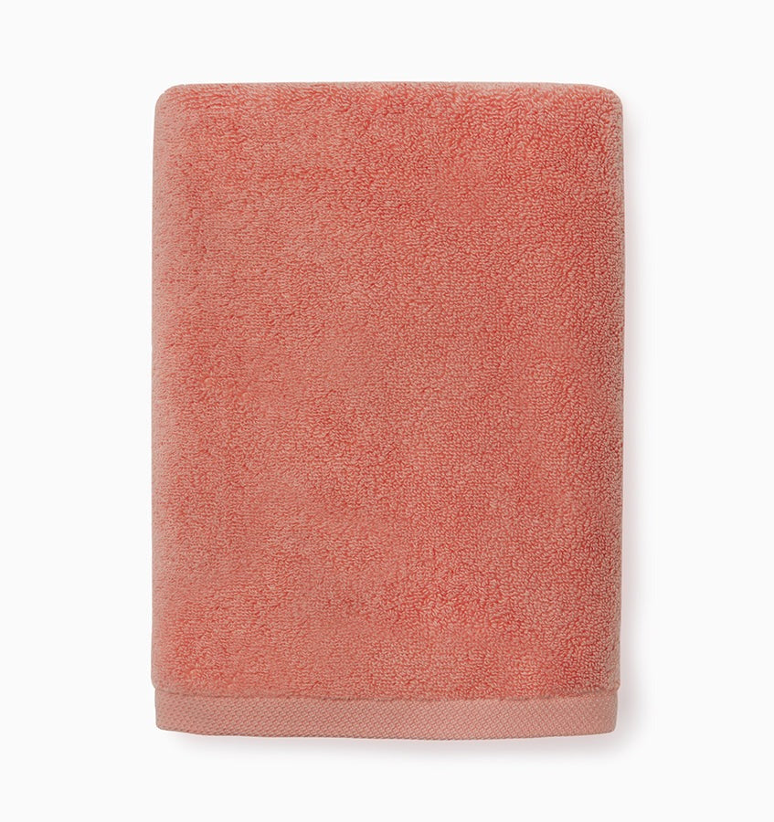 Experience the ultimate in comfort with Sferra's Cielo bath towels and tub mat. Made with the finest long staple cotton and zero-twist yarn, these towels are incredibly absorbent and feel weightless. The result? A heavenly softness that shines with a lustrous surface and catches the light. Indulge in luxury every time you use them. Coral Hand Towel