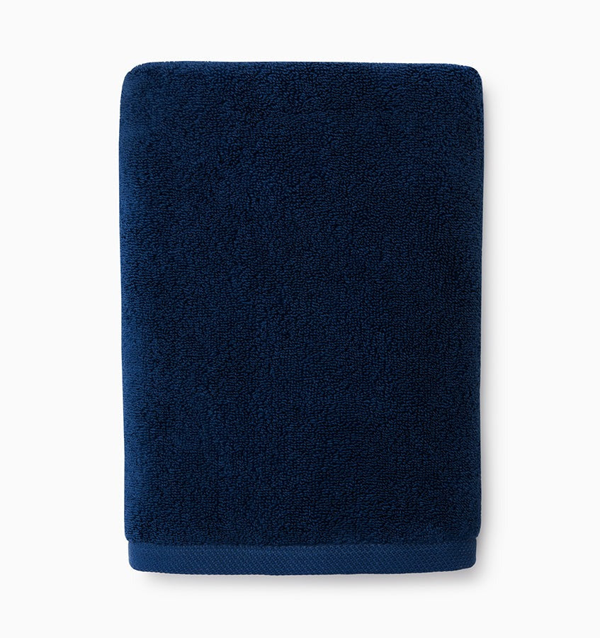 Experience the ultimate in comfort with Sferra's Cielo bath towels and tub mat. Made with the finest long staple cotton and zero-twist yarn, these towels are incredibly absorbent and feel weightless. The result? A heavenly softness that shines with a lustrous surface and catches the light. Indulge in luxury every time you use them. Ink Blue Hand Towel