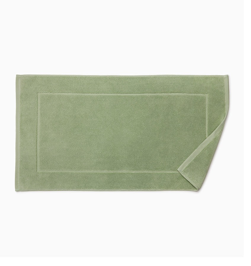 Experience the ultimate in comfort with Sferra's Cielo bath towels and tub mat. Made with the finest long staple cotton and zero-twist yarn, these towels are incredibly absorbent and feel weightless. The result? A heavenly softness that shines with a lustrous surface and catches the light. Indulge in luxury every time you use them. Palm Green Tub Mat