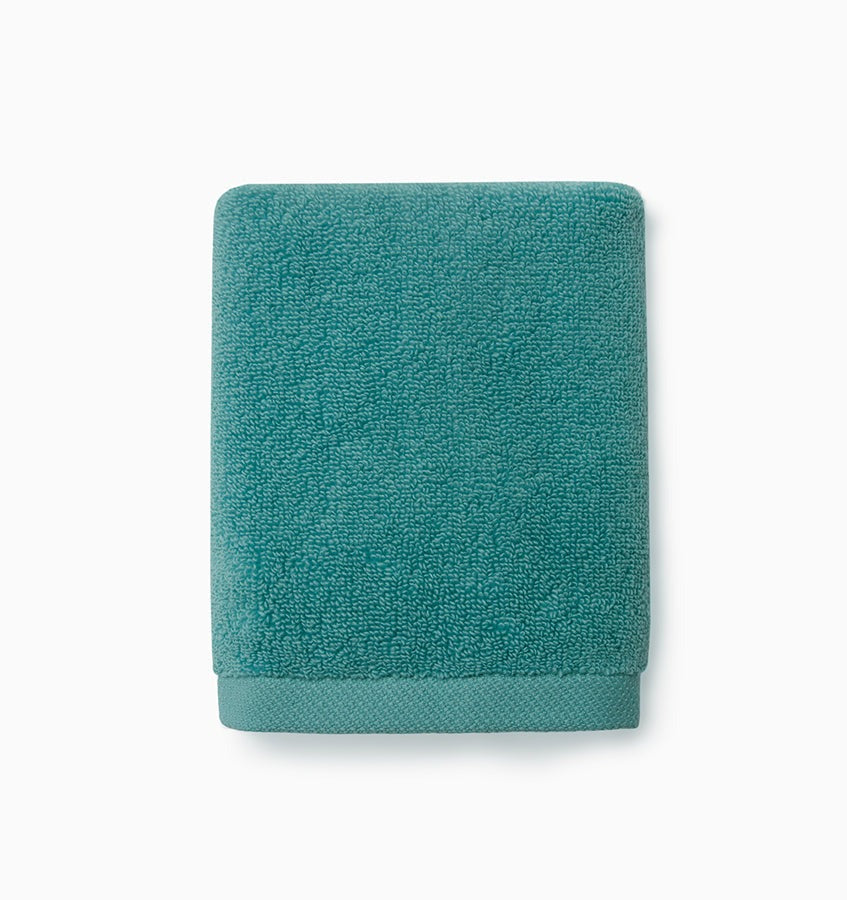 Experience the ultimate in comfort with Sferra's Cielo bath towels and tub mat. Made with the finest long staple cotton and zero-twist yarn, these towels are incredibly absorbent and feel weightless. The result? A heavenly softness that shines with a lustrous surface and catches the light. Indulge in luxury every time you use them. Caribbean Blue Wash Cloth