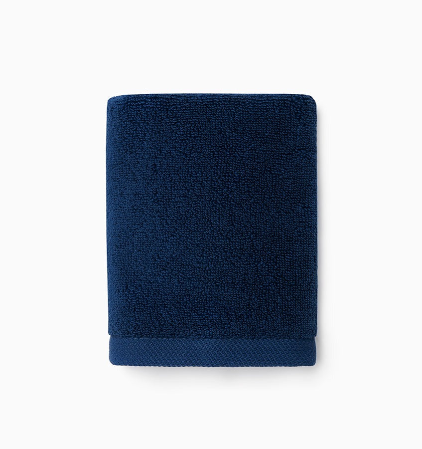 Experience the ultimate in comfort with Sferra's Cielo bath towels and tub mat. Made with the finest long staple cotton and zero-twist yarn, these towels are incredibly absorbent and feel weightless. The result? A heavenly softness that shines with a lustrous surface and catches the light. Indulge in luxury every time you use them. Marine Ink Dark Blue Wash Cloth