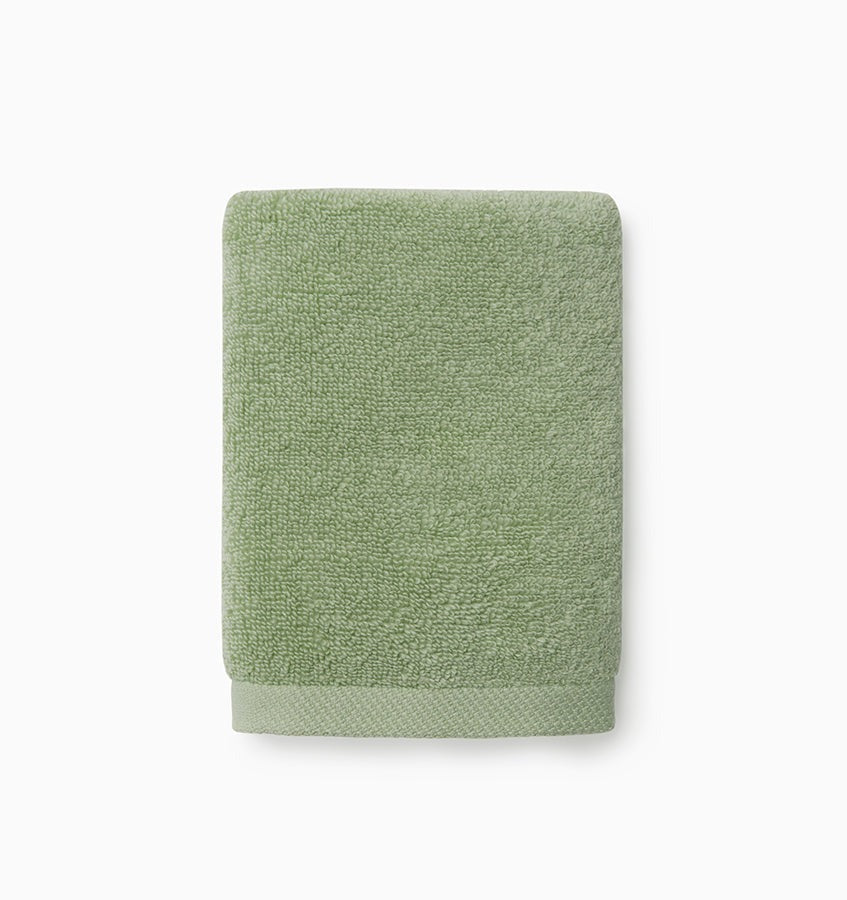 Experience the ultimate in comfort with Sferra's Cielo bath towels and tub mat. Made with the finest long staple cotton and zero-twist yarn, these towels are incredibly absorbent and feel weightless. The result? A heavenly softness that shines with a lustrous surface and catches the light. Indulge in luxury every time you use them. Palm Green Wash Cloth