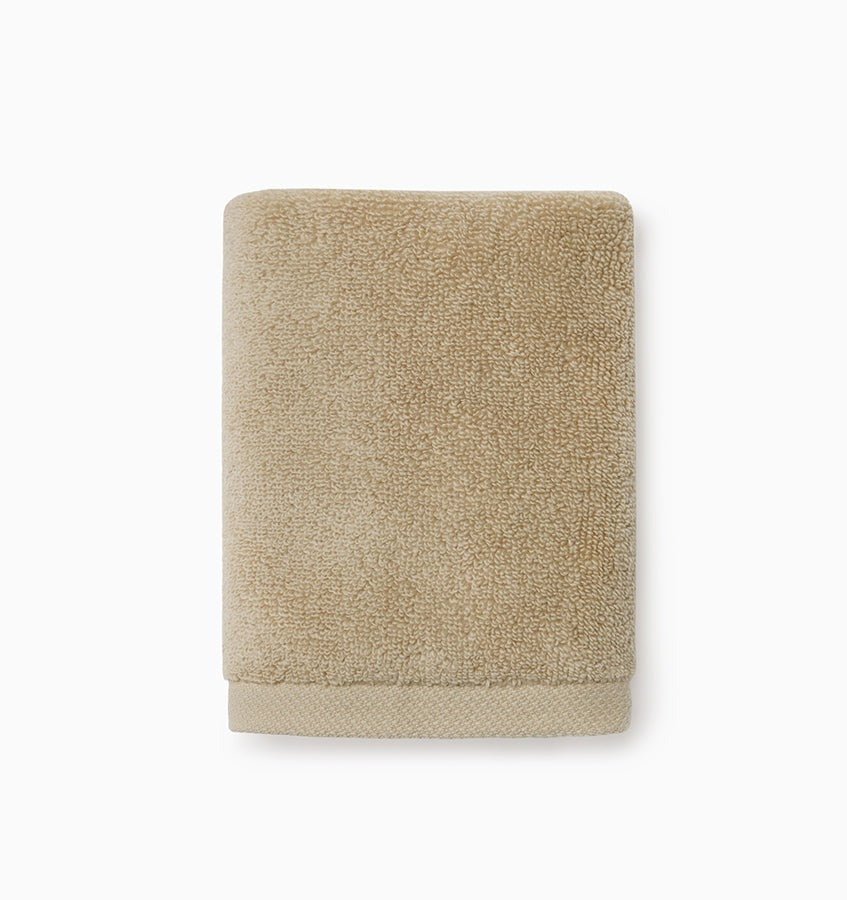 Experience the ultimate in comfort with Sferra's Cielo bath towels and tub mat. Made with the finest long staple cotton and zero-twist yarn, these towels are incredibly absorbent and feel weightless. The result? A heavenly softness that shines with a lustrous surface and catches the light. Indulge in luxury every time you use them. Sand Beige Wash Cloth