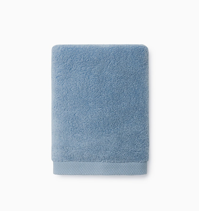 Experience the ultimate in comfort with Sferra's Cielo bath towels and tub mat. Made with the finest long staple cotton and zero-twist yarn, these towels are incredibly absorbent and feel weightless. The result? A heavenly softness that shines with a lustrous surface and catches the light. Indulge in luxury every time you use them. Sea Blue Wash Cloth