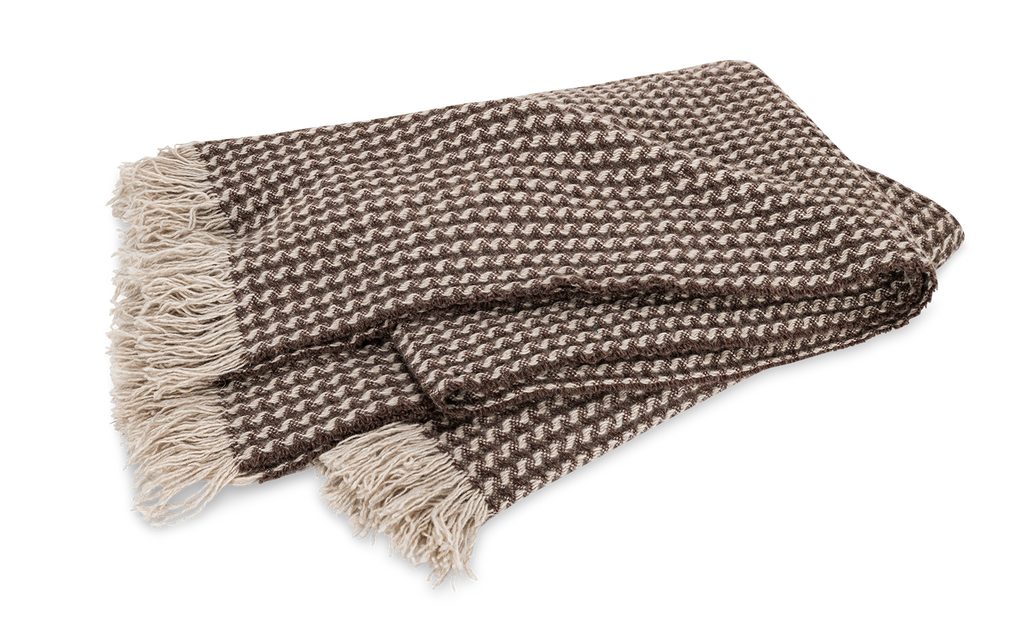 Indulge in pure luxury with the Cleo Cashmere Throw. Made from the softest 100% cashmere and washed using a special method, this oversized throw boasts extra loft and texture. With a subtle basket weave pattern, combed fringe, and understated monochromatic hues, Cleo adds elegant style to any home. Fawn Brown