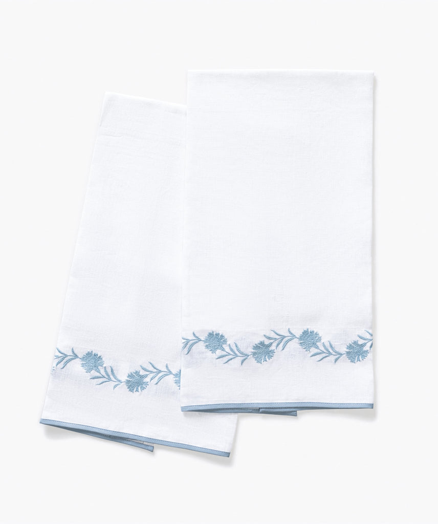 Matouk Daphne Guest Towels in white linen with hazy blue floral embroidery