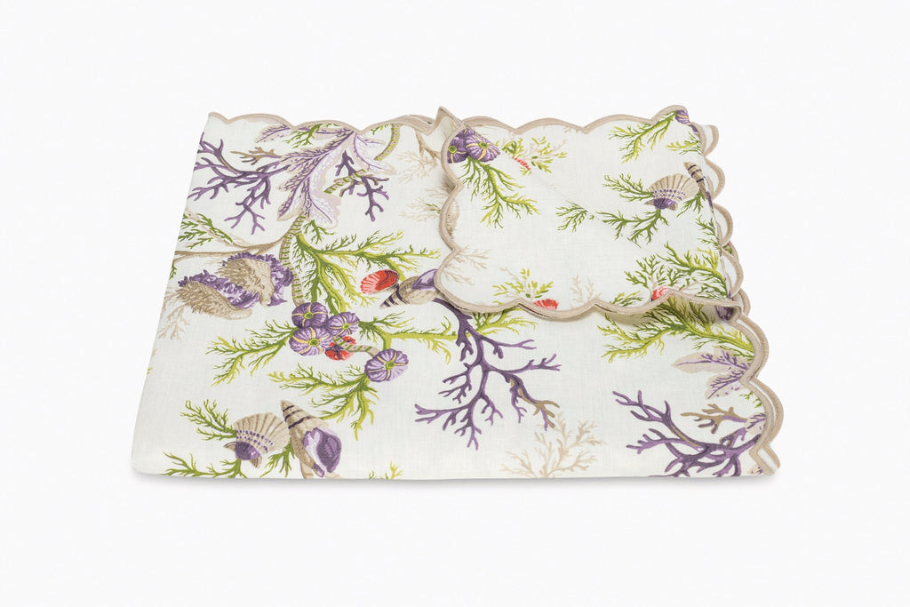 Matouk Schumacher Del Tesoro Linen Tablecloths and Runners feature sea life and coral print on linen finished with a linen embroidered scallop edge