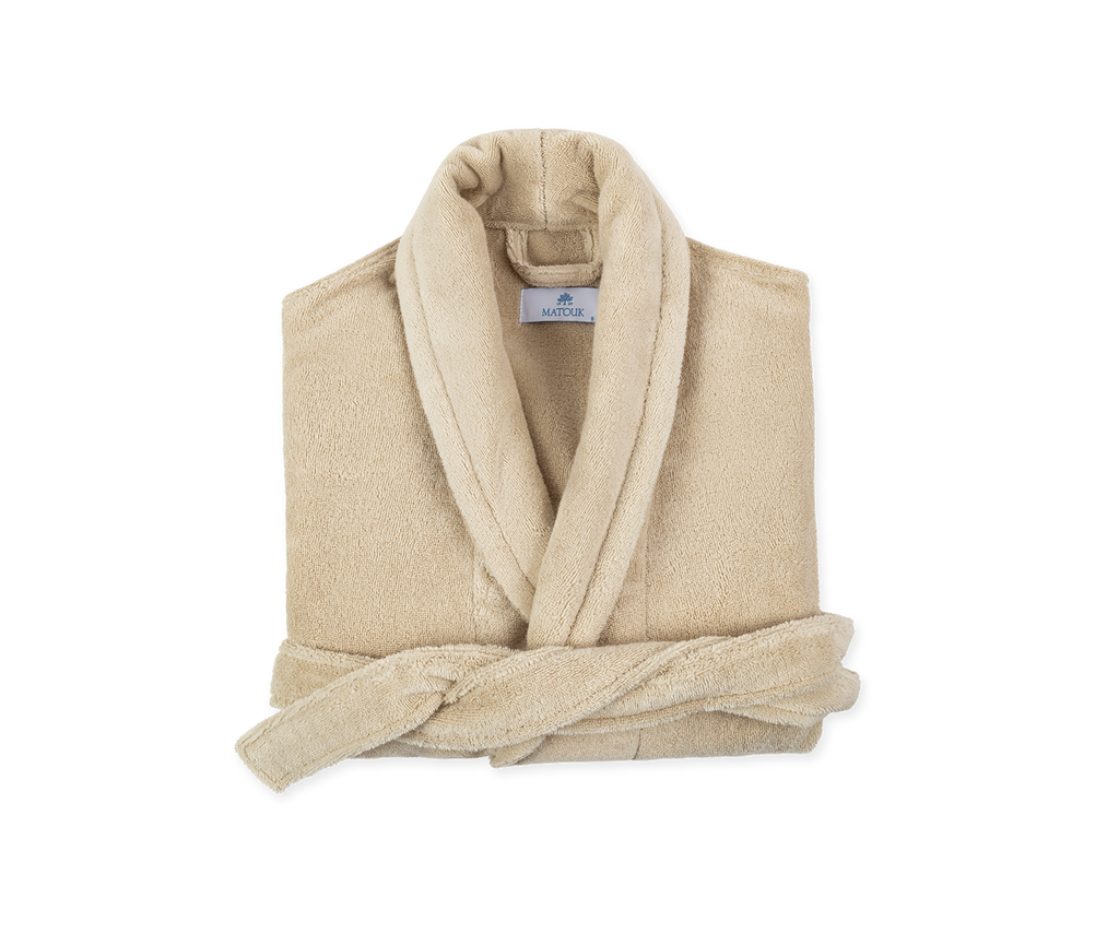 Introducing the luxuriously soft and cozy Milagro Bath Robe from Matouk. Made with 100% zero twist cotton, this unisex robe features a shawl collar and two ample sized pockets. Available in Dune Tan this robe is the perfect addition to your daily routine. Made in Turkey.