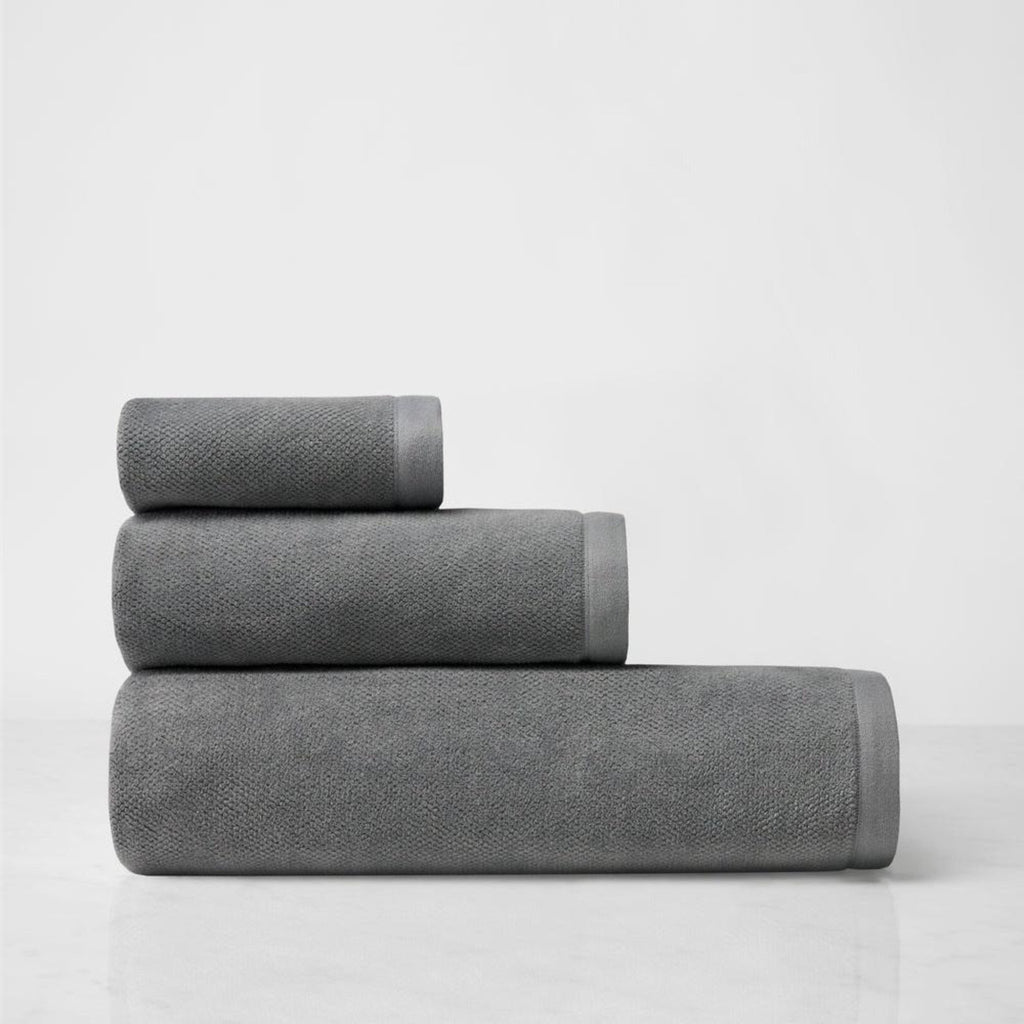 Elevate your bathing experience with Canedo Nuovo Bath Towels + Tub Mat. Crafted by Sferra from long-staple combed cotton, these towels offer a soft and velvety touch to your skin. The diamond-weave velour adds a touch of luxury, while the terrycloth absorbs moisture for a cozy embrace. Available in Charcoal Grey Bath Towel, Bath Sheet, Hand Towel, Wash cloth and Tub Mat