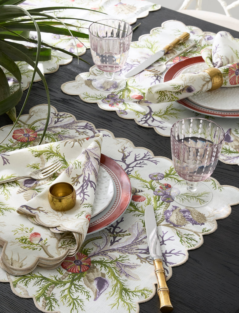 Matouk Schumacher Del Tesoro Linen Napkins, Placemats, Tablecloths, and Runners feature sea life and coral print on linen finished with a linen embroidered scallop edge