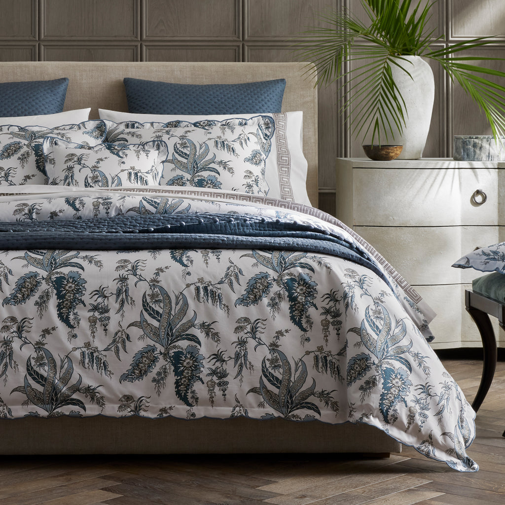 Introducing the Apolline Sheets, Duvet Covers + Shams by Matouk. Inspired by the graceful English countryside, this stunning botanical print features a white Egyptian cotton percale fabric with a Mediterranean blue floral pattern and silvery grey accents. With a subtle scallop edge, these sheets exude sophistication.