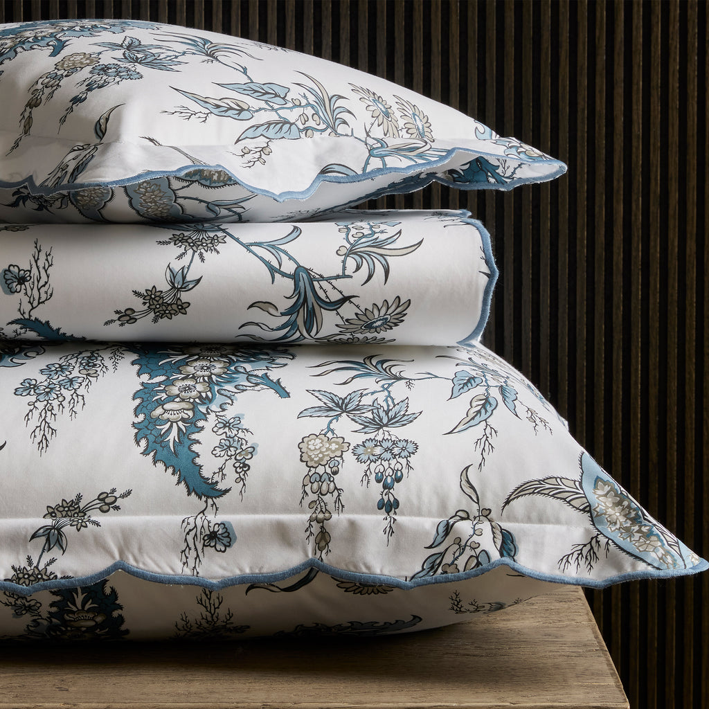 Introducing the Apolline Sheets, Duvet Covers + Shams by Matouk. Inspired by the graceful English countryside, this stunning botanical print features a white Egyptian cotton percale fabric with a Mediterranean blue floral pattern and silvery grey accents. With a subtle scallop edge, these sheets exude sophistication.