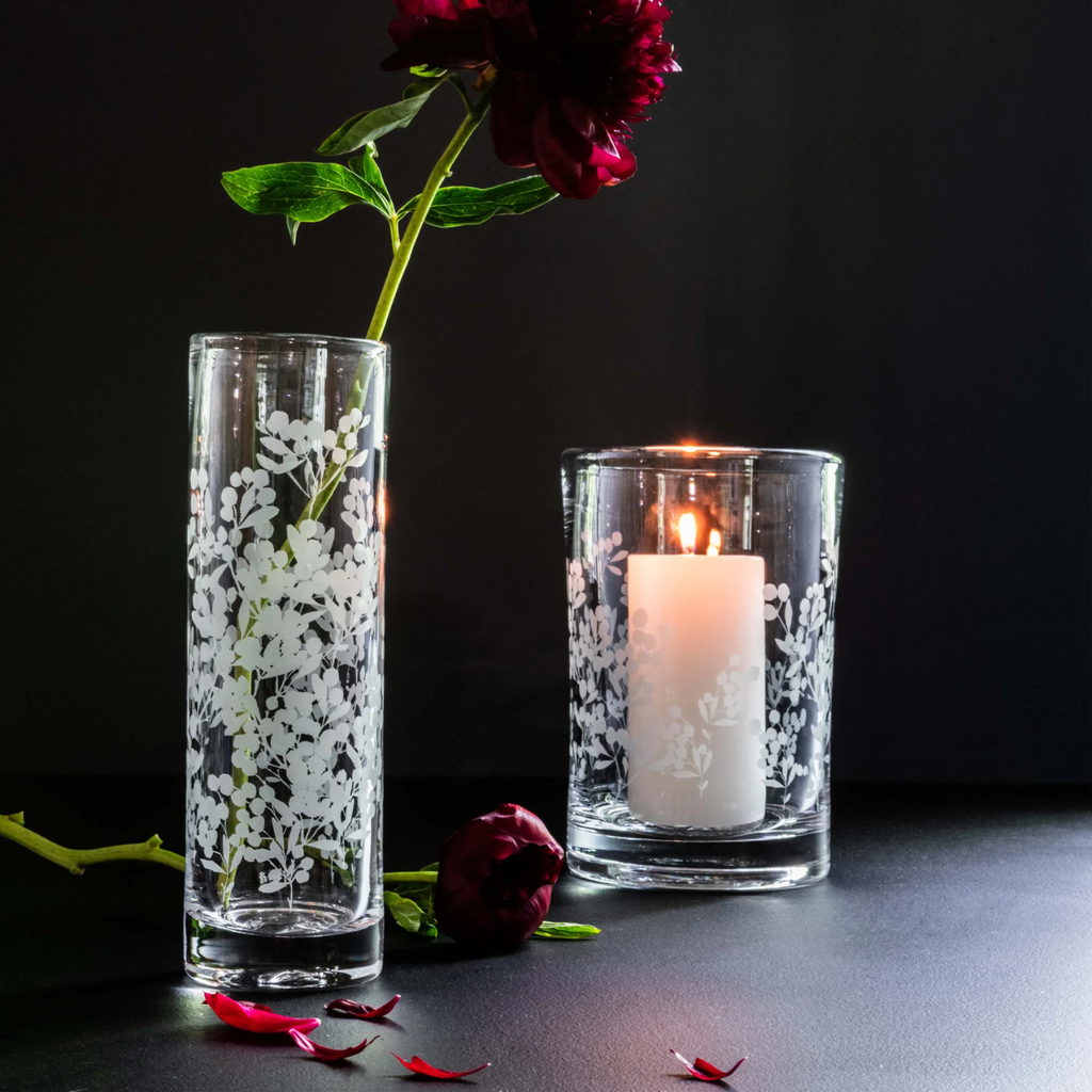 Crafted with precision and elegance, Simon Pearce's Engraved Berry Vase and hurricane is the perfect addition to any home decor. Made with high-quality materials, they feature intricate berry engravings that add a touch of sophistication to any space. Enjoy the beauty and functionality of this timeless piece.