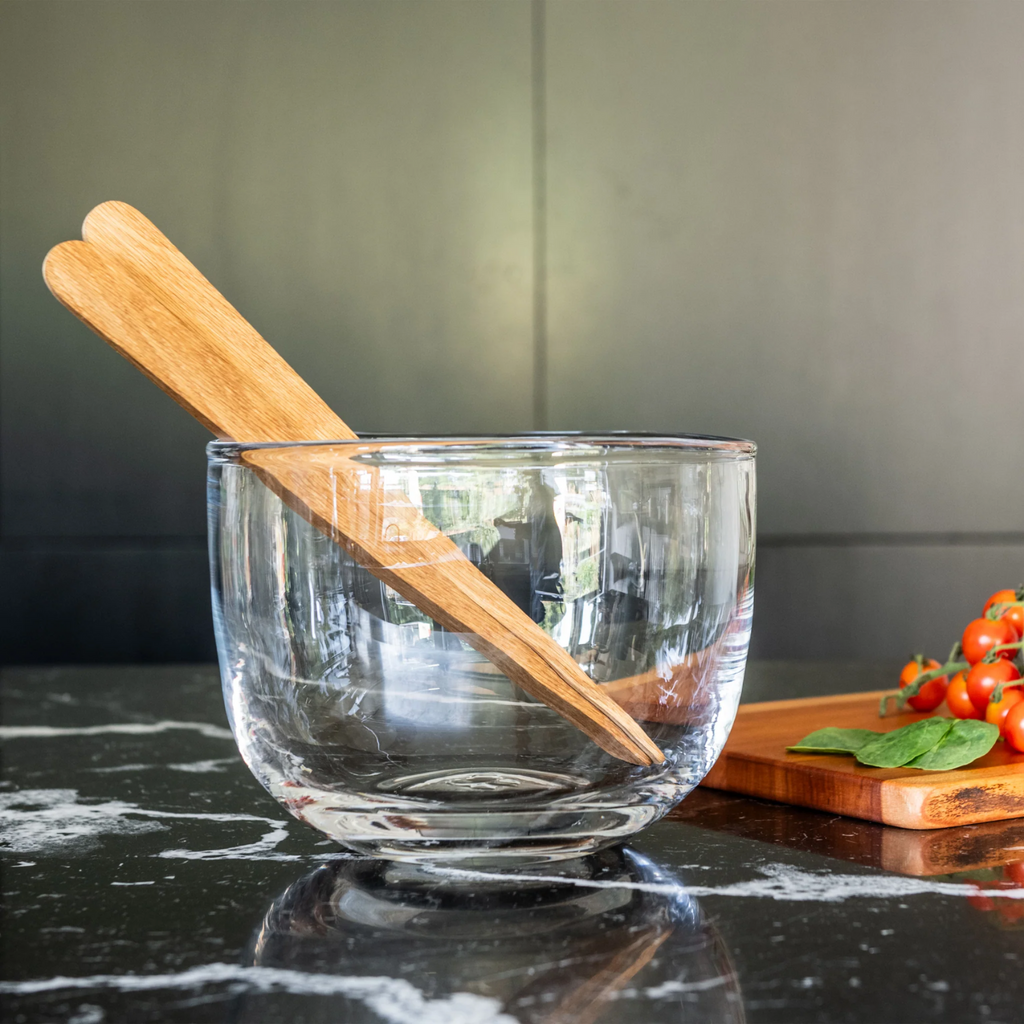 Experience the natural, artisanal charm of Burlington with our inspired glass bowl from Simon Pearce. Its handcrafted design gives it a lively, imperfect feel, making it perfect for both simple centerpieces and as a beautiful salad bowl. Its free-flowing lines and organic shape add a touch of fluidity to any setting.