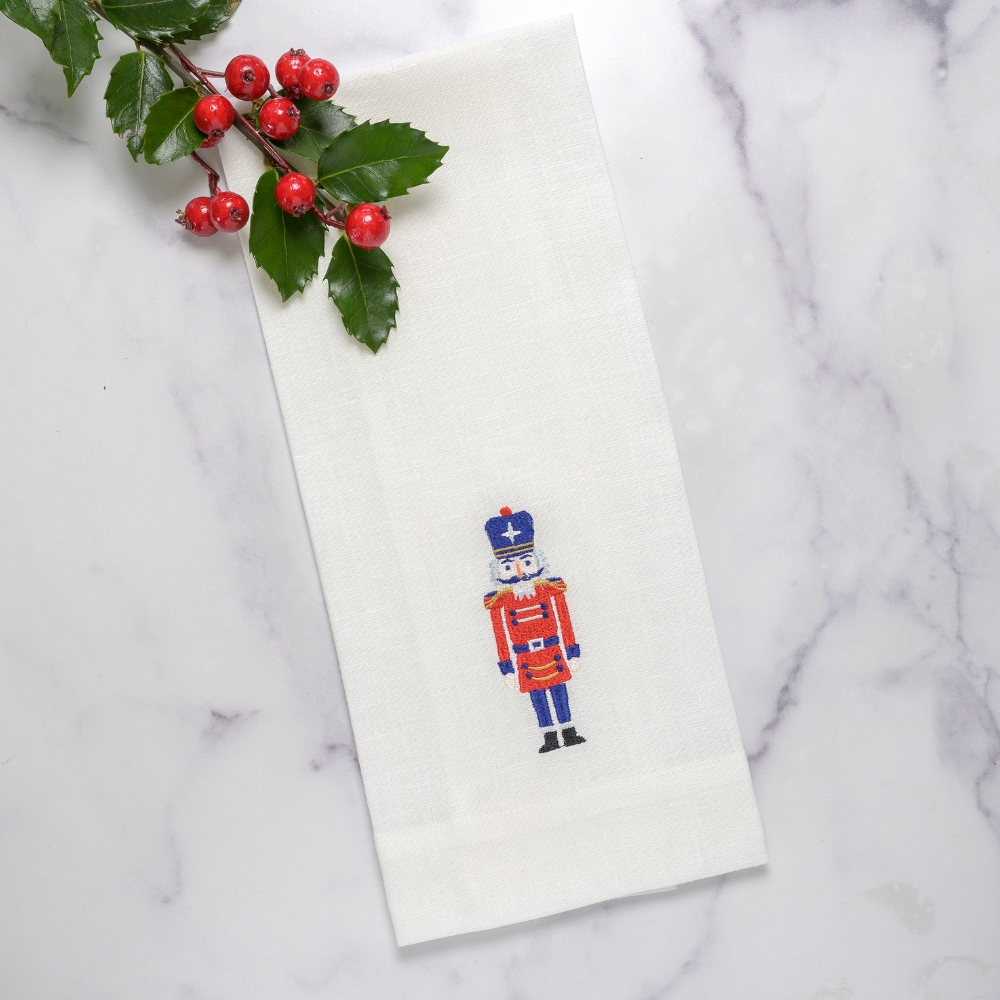 Add festive charm to your kitchen or bath with our Nutcracker towel. Made from 100% European linen and embroidered with intricate detail, it's a beautiful addition to any home. Perfect for hanging with its convenient tab, bring a touch of Italy to your decor.