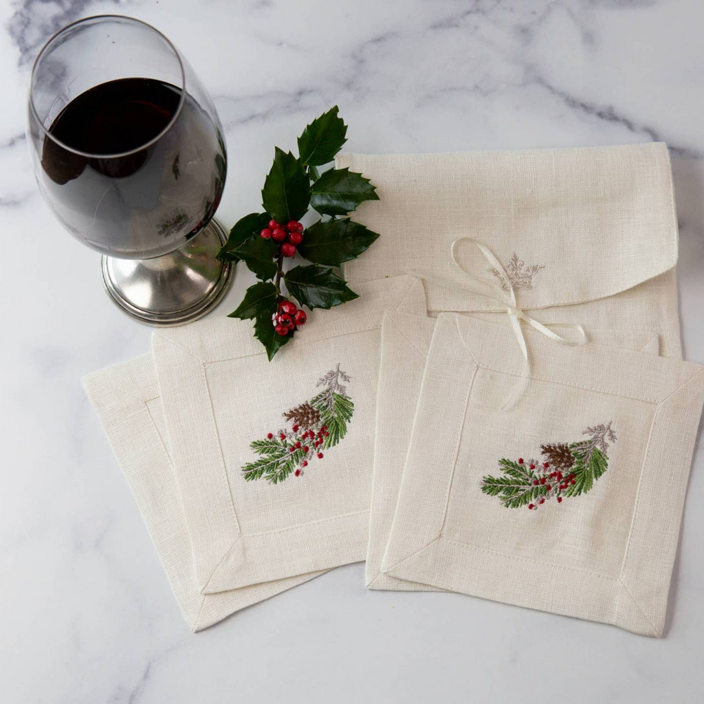 Natale Cocktail Napkin Set, made from 100% European linen and delicately embroidered with our signature "Natale Sprig" emblem. Timeless set of four cocktail napkins, perfect for hosting guests or gifting to loved ones. Each napkin measures 6" x 6" and comes in a linen pouch for safe keeping. Made in Ukraine. Crown Linen Designs