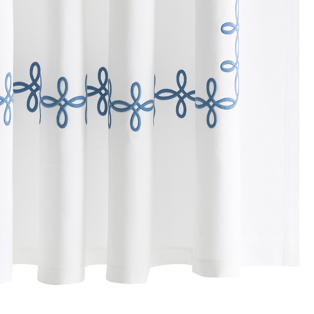 Elevate your bathroom with our elegant Gordian Knot Shower Curtain from respected bath and bed designers at Matouk. Crafted with a Grecian inspired pattern in Ocean blue embroidered color, our timeless design is meticulously perfected on white pique fabric. Experience luxury every time you step into your shower.