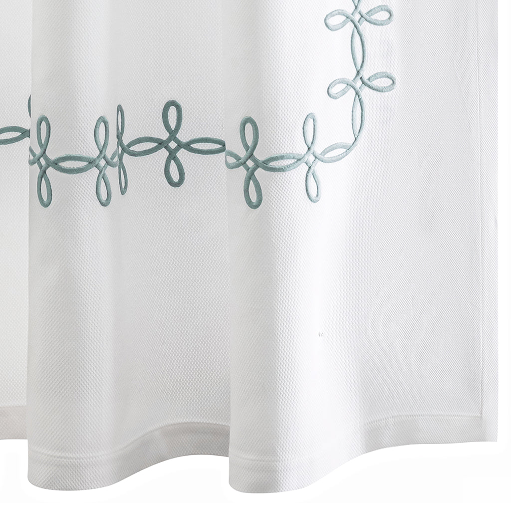 Elevate your bathroom with our elegant Gordian Knot Shower Curtain from respected bath and bed designers at Matouk. Crafted with a Grecian inspired pattern in Pool blue embroidered color, our timeless design is meticulously perfected on white pique fabric. Experience luxury every time you step into your shower.