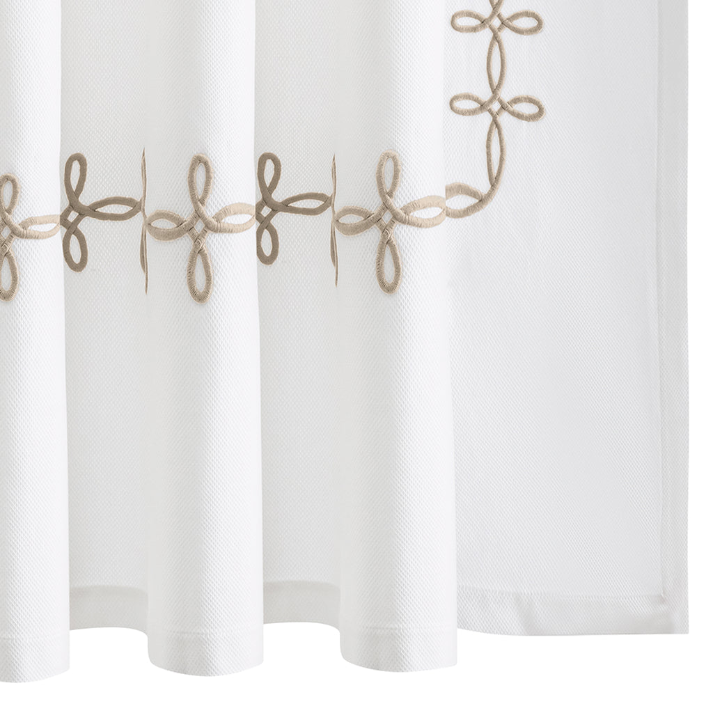 Elevate your bathroom with our elegant Gordian Knot Shower Curtain from respected bath and bed designers at Matouk. Crafted with a Grecian inspired pattern in warm truffle brown embroidered color, our timeless design is meticulously perfected on white pique fabric. Experience luxury every time you step into your shower.