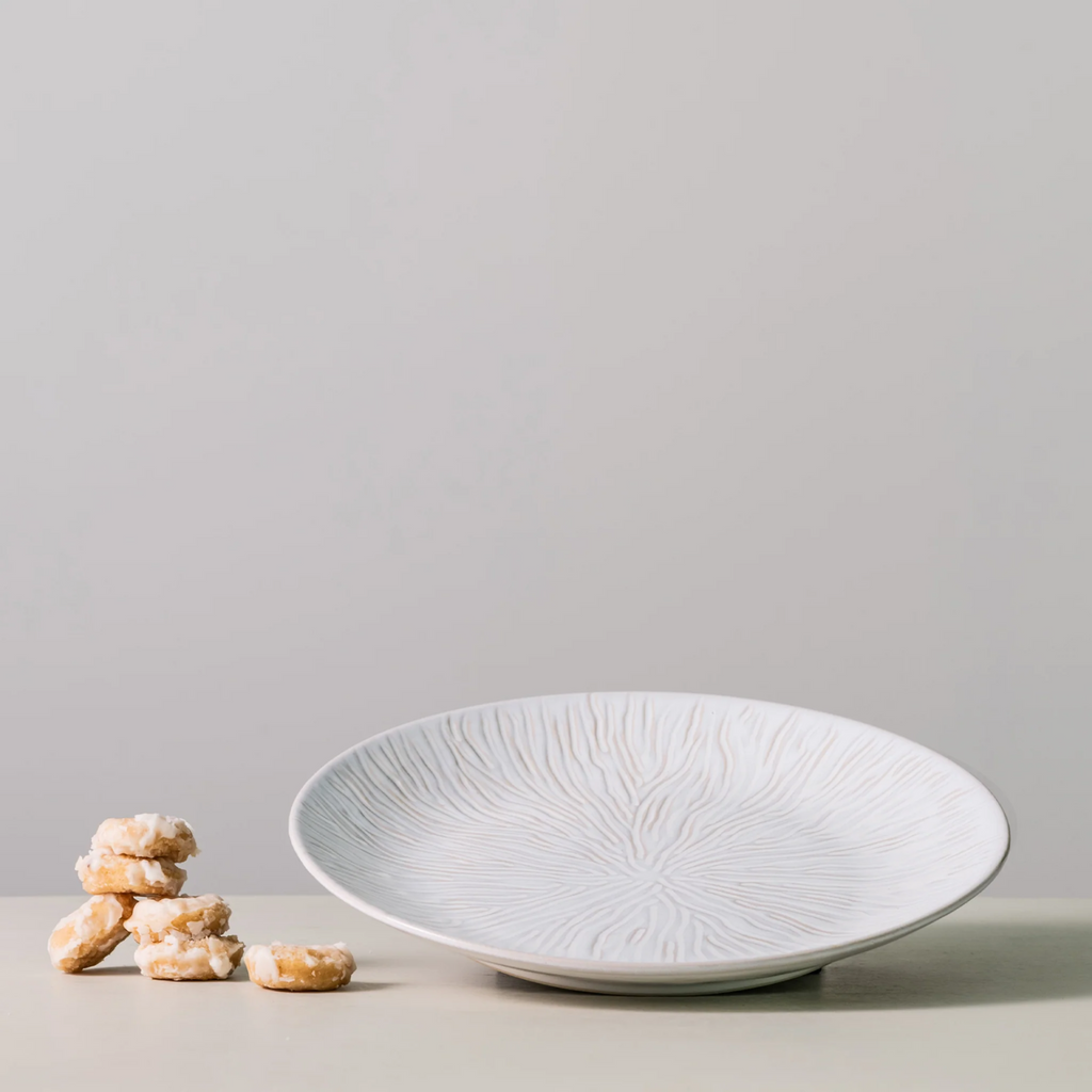 This elegant Harvest Field Platter is perfect for serving up your favorite autumn dishes. With its spacious design and durable construction, it's the ideal choice for any fall gathering. Impress your guests and elevate your dining experience with the Harvest Field Platter by Simon Pearce.