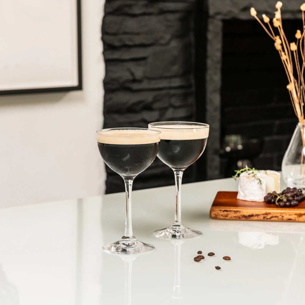 Indulge in the luxurious charm of the Vintner Nick & Nora Glass from Simon Pearce. Named after the iconic detectives, this glass features an upsized bowl for effortless mixing and sipping. With a thin rim and elegant stem design, it's perfect for your favorite cocktails.