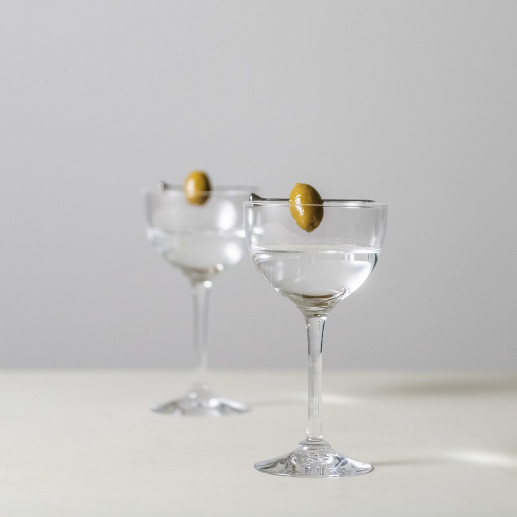 Indulge in the luxurious charm of the Vintner Nick & Nora Glass from Simon Pearce. Named after the iconic detectives, this glass features an upsized bowl for effortless mixing and sipping. With a thin rim and elegant stem design, it's perfect for your favorite cocktails.